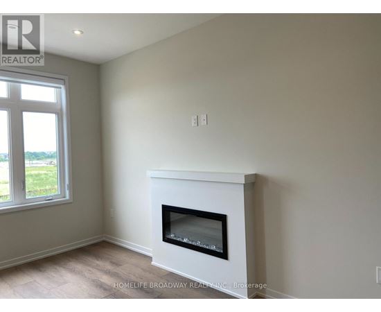 A white fireplace in a room with a window.