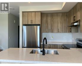 A modern kitchen with a sink and wooden cabinets.