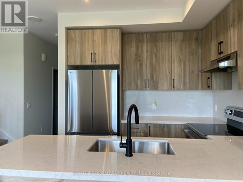 A modern kitchen with a sink and wooden cabinets.