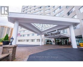 A large white canopy structure is in front of a building with a sign that reads "Place Royale".