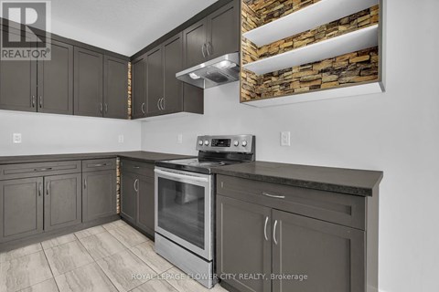 A kitchen with a stove top oven and cabinets.