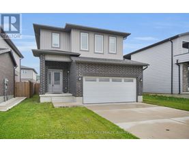 A two-story house with a garage is for sale.