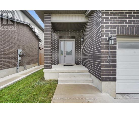 A brick house with a grey door and a white garage door.