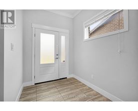 A white door is in a room with a window.