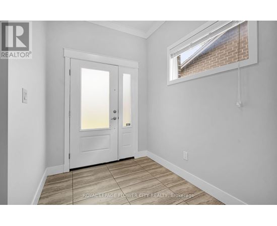 A white door is in a room with a window.