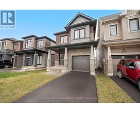 A row of houses with a red car parked in front of the first house.