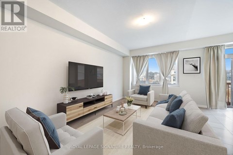 A living room with a grey couch and a flat screen TV.