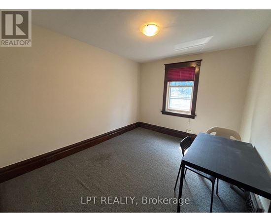 A room with a table and a chair in it.