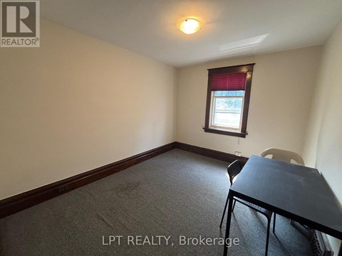 A room with a table and a chair in it.