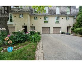 A house with a driveway and a sign that says REALTOR.