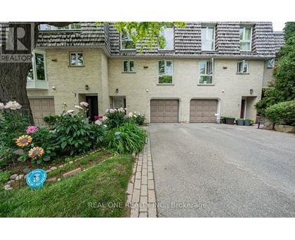 A house with a driveway and a sign that says REALTOR.