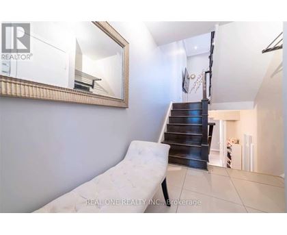 A white chair is placed in a room with a mirror on the wall.