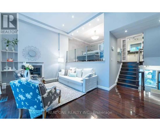 A living room with a blue chair and a white couch.