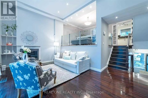 A living room with a blue chair and a white couch.