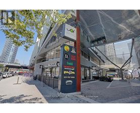 A street view of a shopping center with various stores including Montfort, Chasera, and a brew pub.