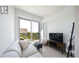 A living room with a white couch and a flat screen TV.