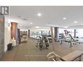 A gym with a variety of equipment including weights and benches.