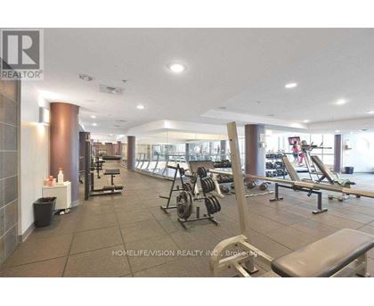 A gym with a variety of equipment including weights and benches.