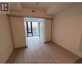 A room with a sliding door leading to a balcony.