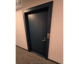 A black door with a silver handle and lock.