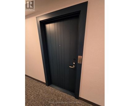 A black door with a silver handle and lock.