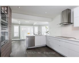 A modern kitchen with white cabinets and a stainless steel dishwasher.