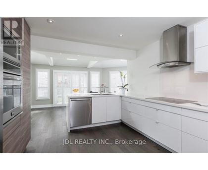 A modern kitchen with white cabinets and a stainless steel dishwasher.