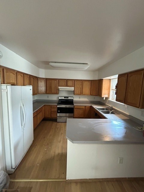 A kitchen with wooden cabinets and a white refrigerator.