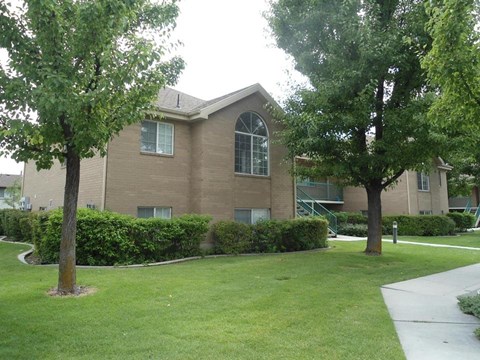 A building with a green lawn in front.