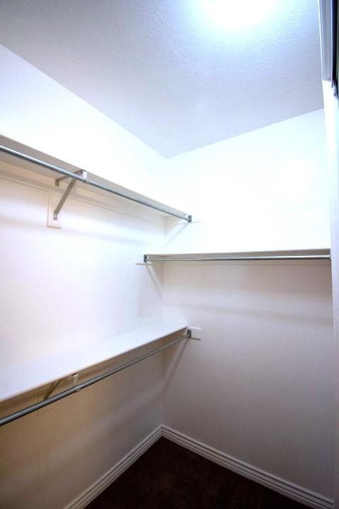A white wall with a shelf and a light on.