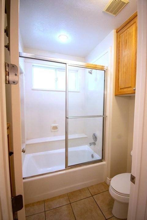 A small bathroom with a toilet and a walk in shower.