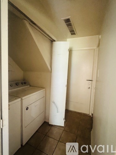 A small kitchen with a white oven and a white fridge.