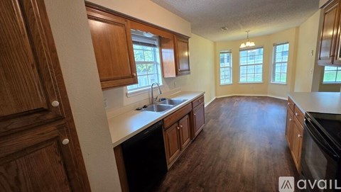 A room with wooden flooring and a ceiling fan.
