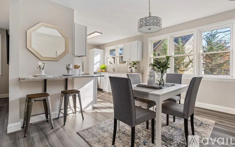 A dining area with a table and chairs.