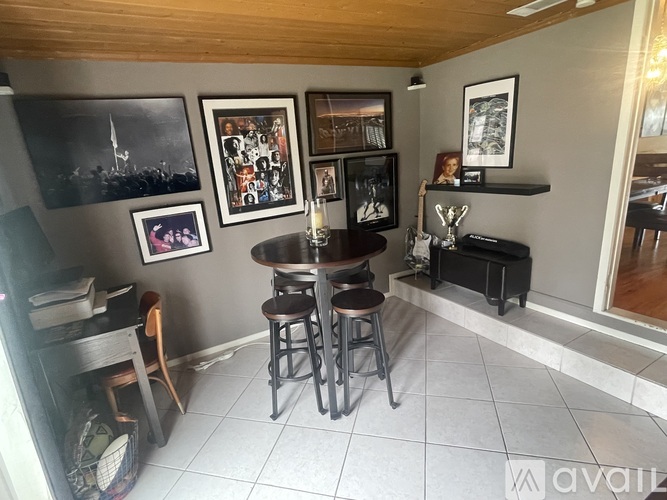A dining area with a table and chairs.