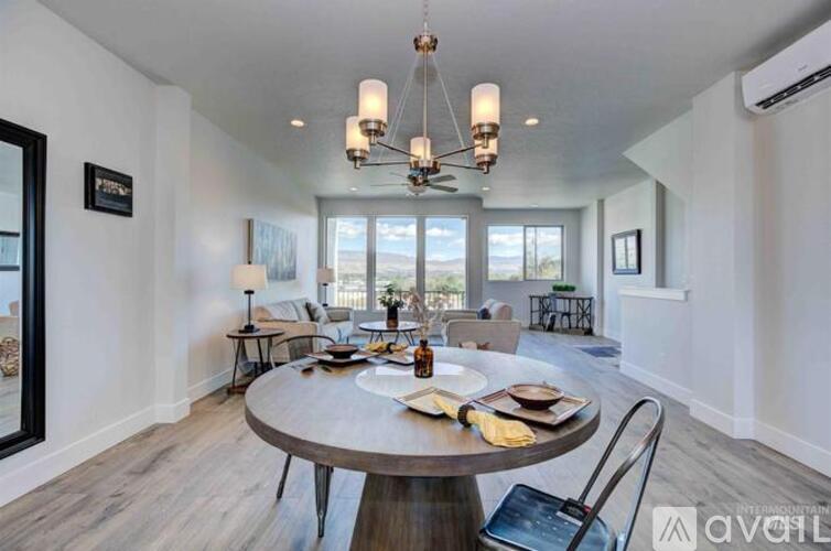 A modern dining room with a round table and chairs.