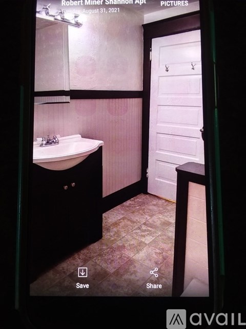 A bathroom with a white sink and a white door.