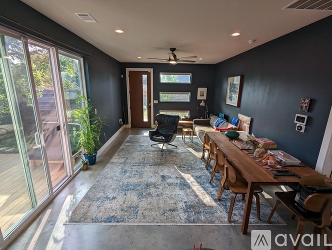 A living room with a dining table and chairs.