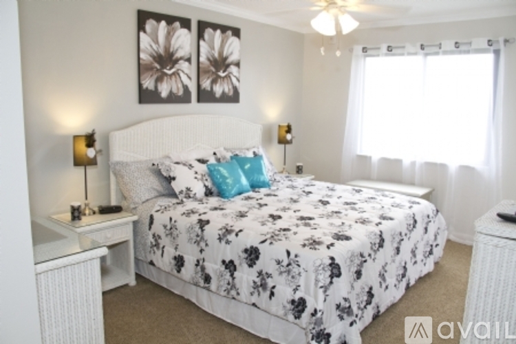 A bedroom with a large bed and floral bedspread.