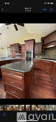 A kitchen with wooden cabinets and a granite countertop.