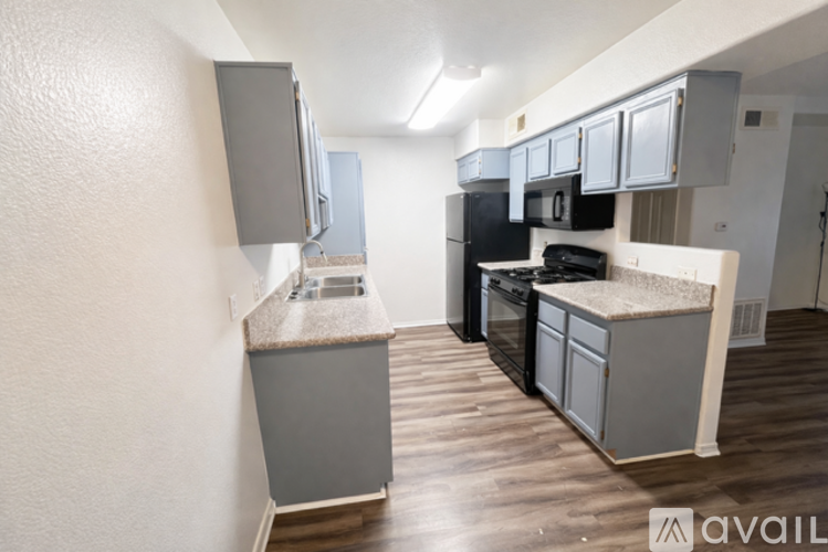 A kitchen with a black stove top oven and a black microwave.