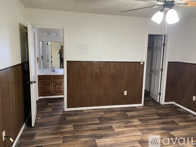 A room with wooden flooring and a ceiling fan.