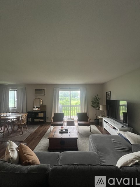 A living room with a grey couch and a wooden coffee table.