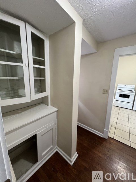 A kitchen with white cabinets and a white oven.