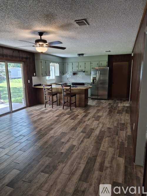 A kitchen with a table and chairs in the middle of the room.