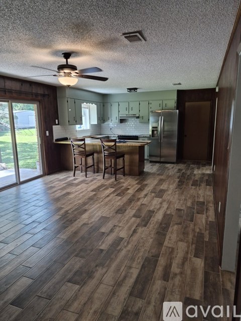 A kitchen with a table and chairs in the middle of the room.