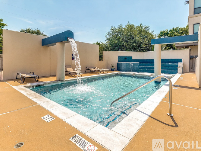 A pool with a waterfall feature in the middle of it.