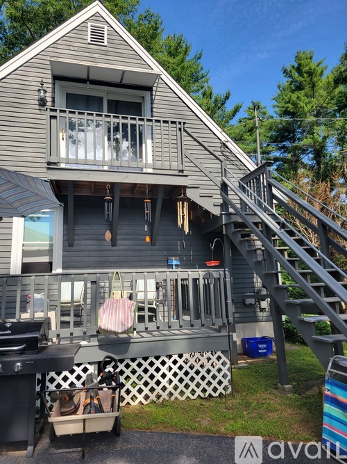 A house with a deck and a hot tub.