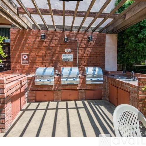 A patio with a table and chairs and a hot tub.
