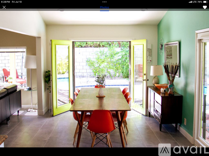 A dining room with a table and chairs.